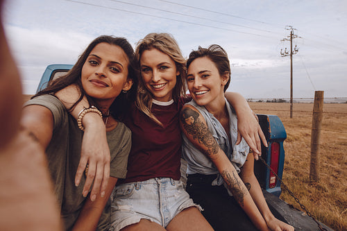 Group of women taking a selfie on pickup truck