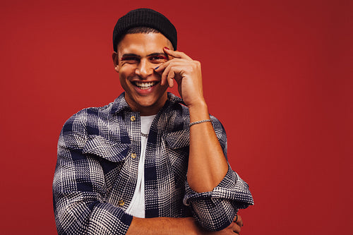 Stylish young man smiling in a studio