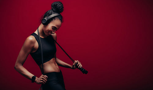 Smiling woman with a jumping rope