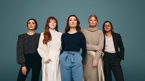 Confident women standing together in a studio