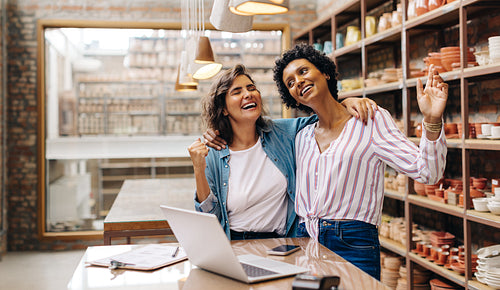 Happy ceramists celebrating their achievement in their shop