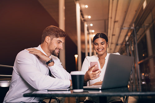 Happy business people waiting at airport cafe