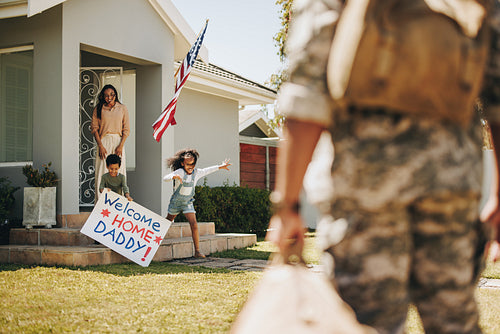 Excited young children welcoming their father from the army