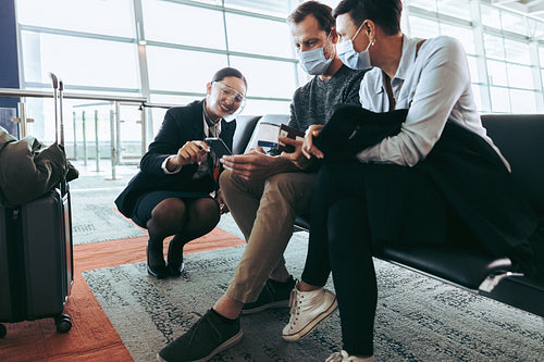 Couple getting help from flight attendant at airport