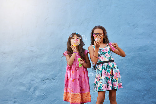 Cute little girls blowing soap bubbles