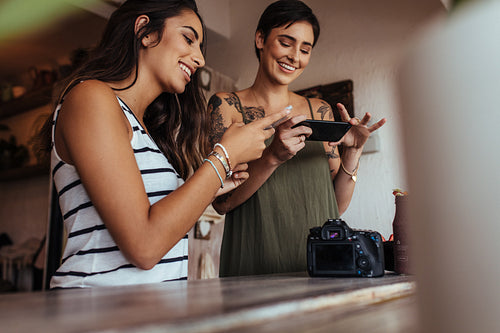 Woman food bloggers taking pictures of food stuff