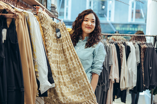 Clothing store owner assisting customer