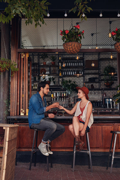 Couple sharing cigarette at coffee shop