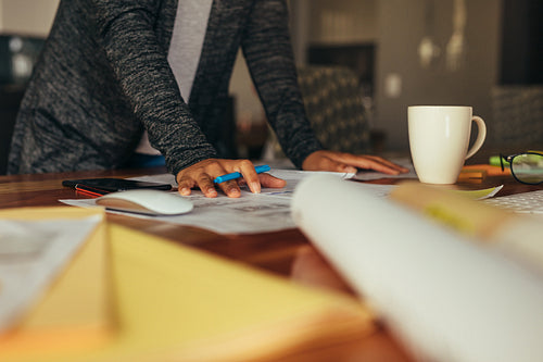 Woman designer working on building plan