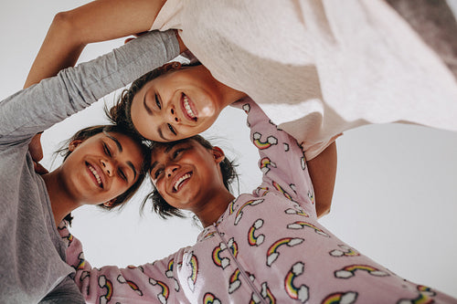 Low angle view of three girls standing together