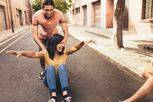Couple having fun with skateboard