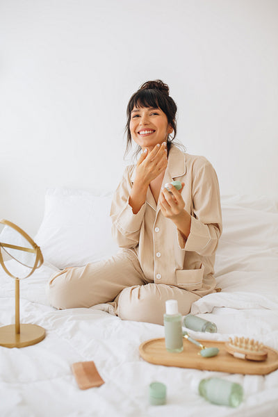 Smiling woman using beauty cosmetics at home