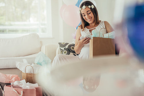  Expecting mother opening gifts received at baby shower