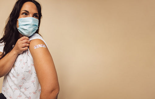 Woman after receiving covid-19 vaccine on her arm
