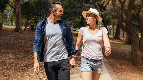 Smiling couple in love walking in the park