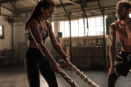 Woman at gym with trainer