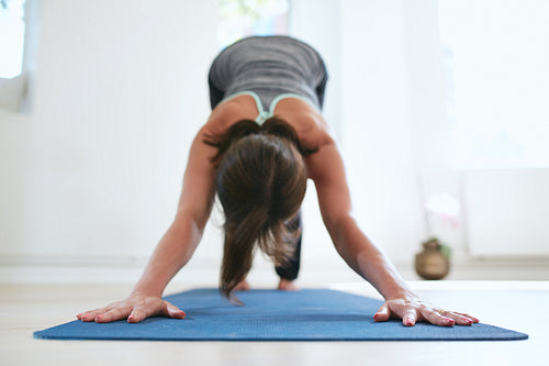 Woman doing Adho Mukha Svanasana yoga pose