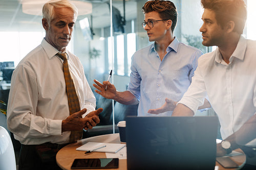 Business people standing at the table and discussing
