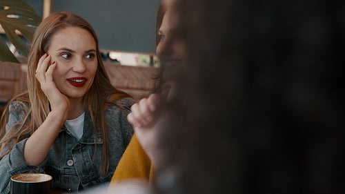 Friends hanging out in a cafe and gossiping