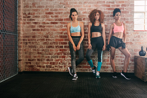 Fitness women standing together in gym
