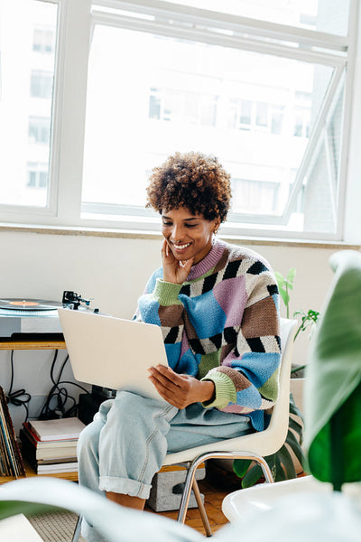 Freelance professional smiling while working in a co-working space