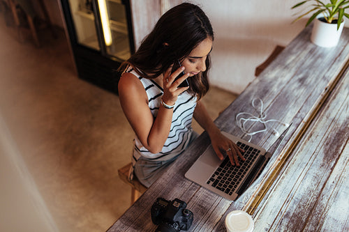 Woman blogger at work on her laptop computer