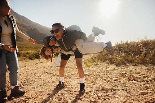 Friends playful outdoors in sunny nature