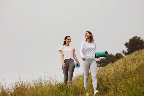 Women friends walking outdoors for fitness