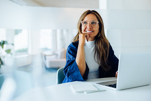 Businesswoman at laptop in a stylish office