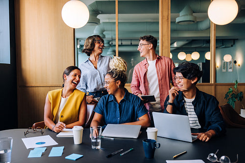 Team of diverse professionals having a cheerful discussion during a business gathering