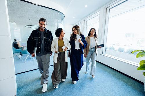 Business colleagues walking in office demonstrating teamwork