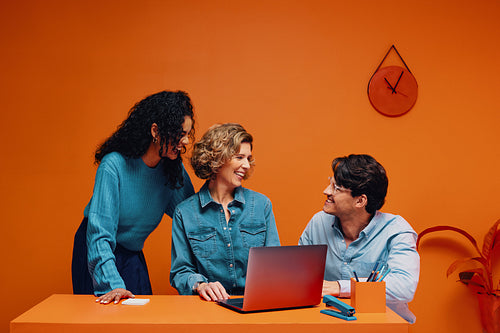 Freelancers having a business meeting in a modern office with color blocking accents