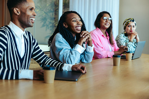 Enthusiastic team of colleagues in a morning meeting