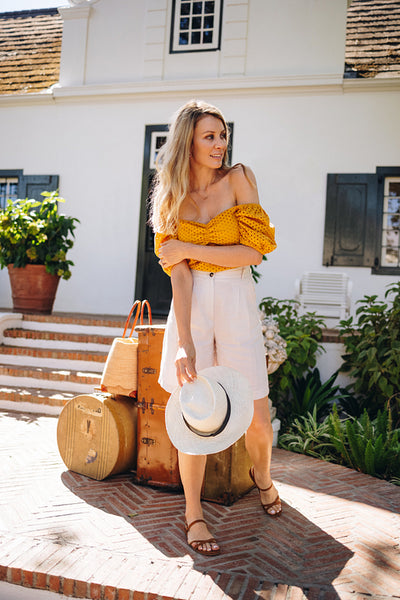 Traveller looking out for her taxi outside a hotel