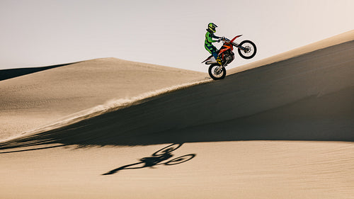 Motocross rider riding uphill