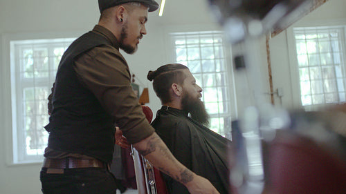 Barber serving client in hair salon