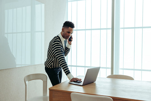 Executive multitasking with technology in a modern office setting