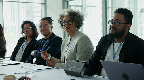 Diverse professionals discuss ideas in meeting