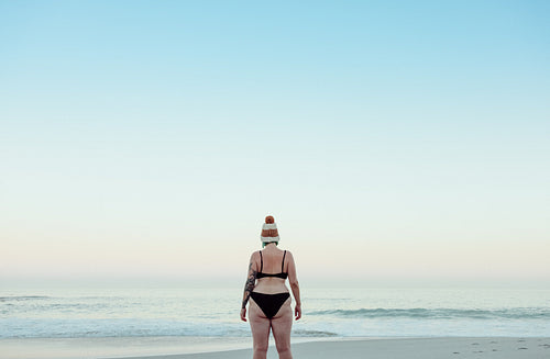 Unrecognizable winter bather standing at the beach