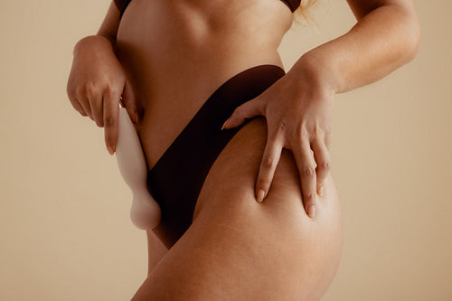 Woman holding a vibrator, embracing self-pleasure in empowering erotic fantasy