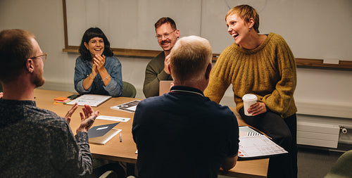 Businesswoman sharing good news in meeting