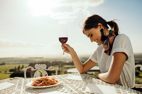 Portrait of a smiling woman drinking wine