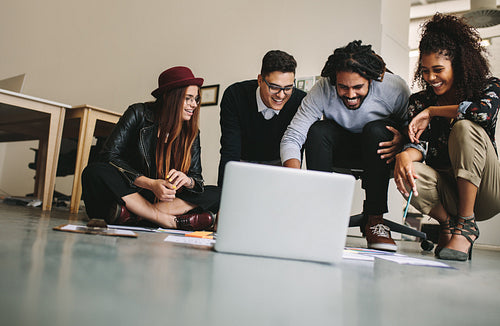 Business colleagues working together sitting on the floor
