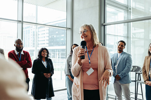 Mature businesswoman leading teambuilding session with coworkers