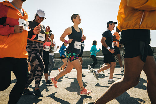 Young female runners participating in a marathon event outdoors
