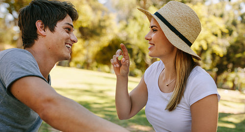 Happy couple sitting in a park