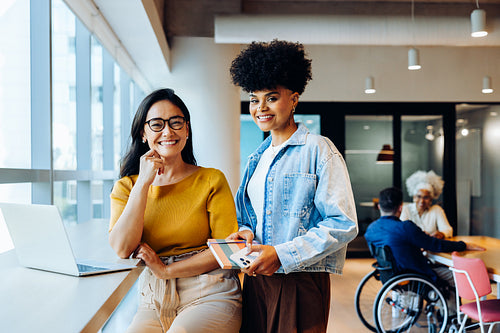 Two women collaborate in a modern office