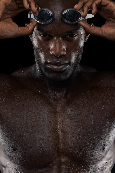 Determined male swimmer with goggle