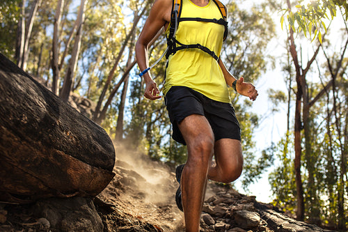 Male runner running on rocky mountian trail