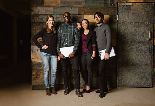 Group of diverse colleagues standing in an office